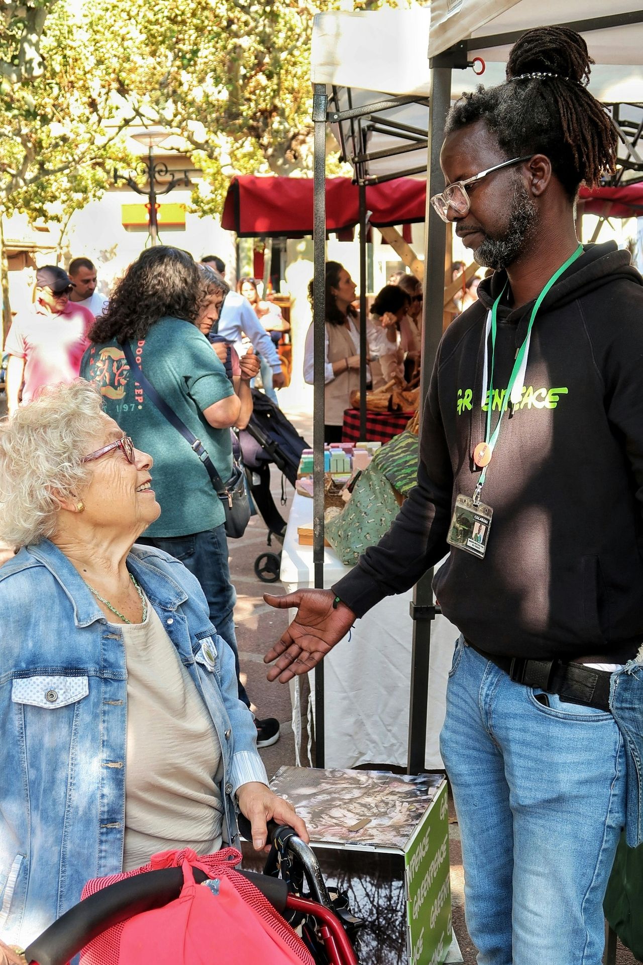 Man talking to woman at outdoor market